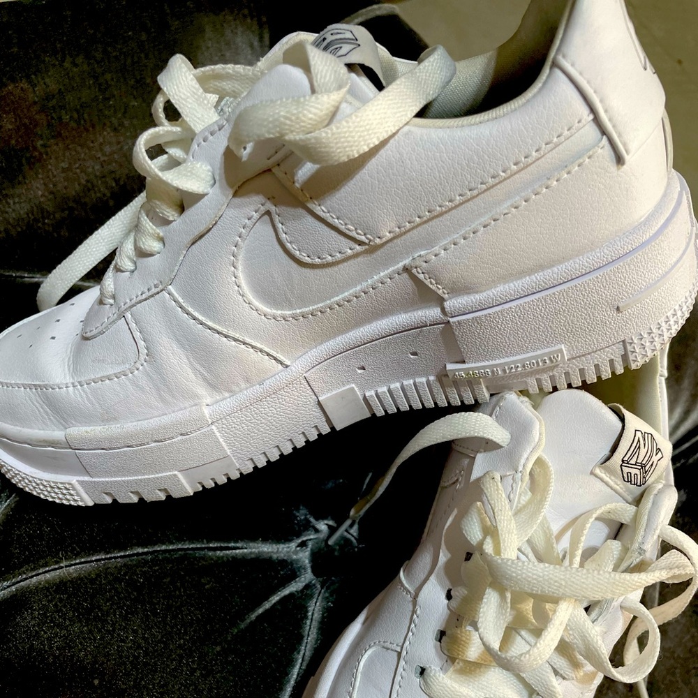 Girls Size 5 Nike Air Force sneaker in white.